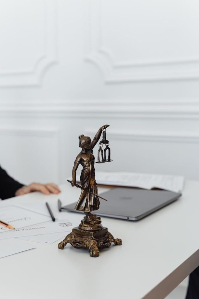 Close-Up Shot of a Lady Justice Figurine on a White Table